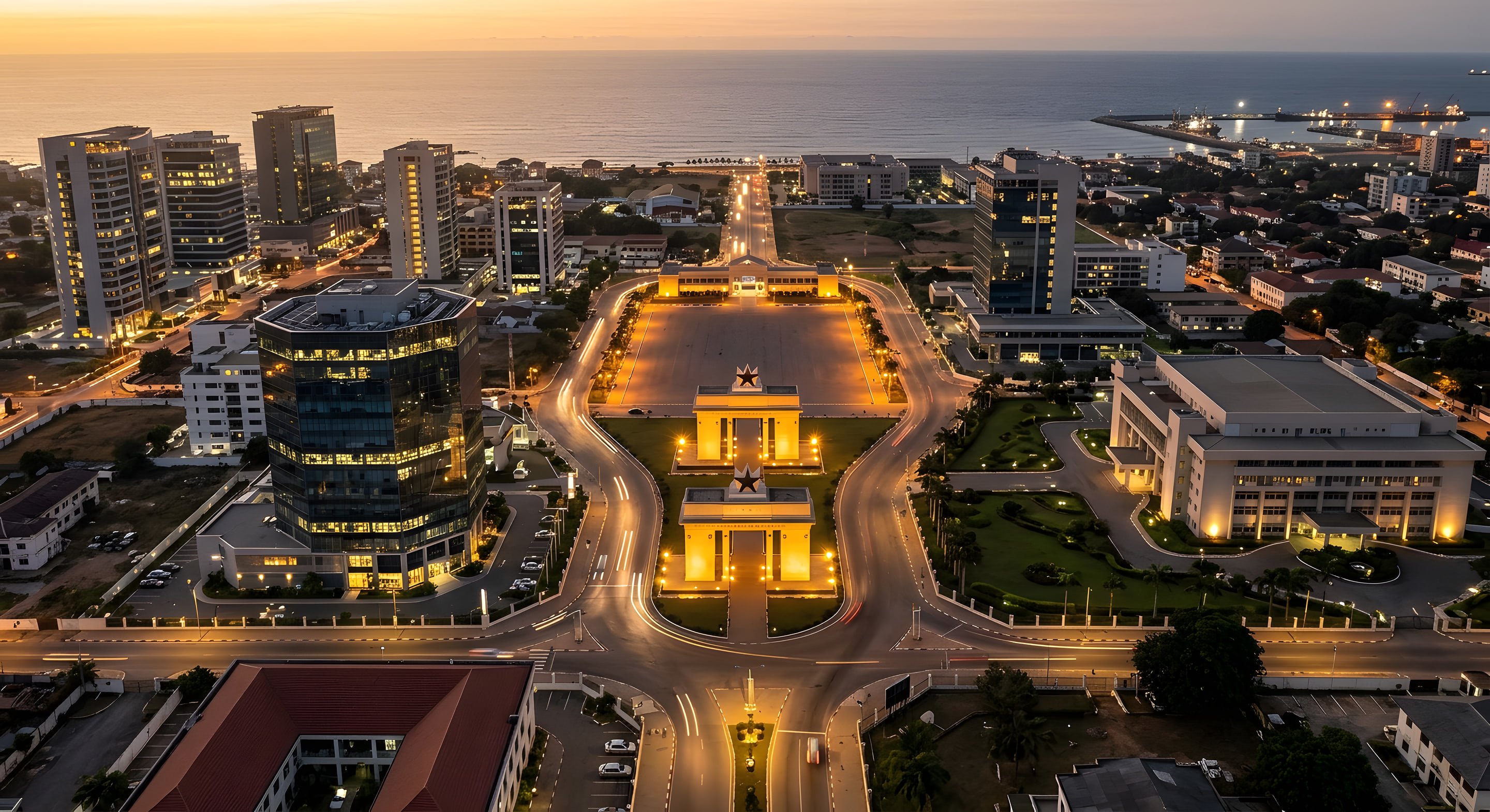 Aerial view of Accra's Independence Square and the Atlantic coastline at dusk